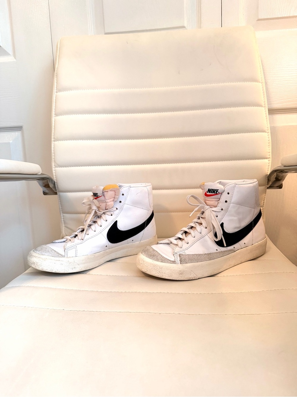 Nike White High-Top Sneakers with Black Swoosh and Yellow Tongue Accent